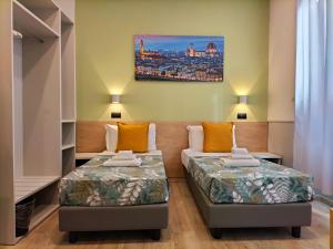 Postel nebo postele na pokoji v ubytování Hotel Camilla Guelfa