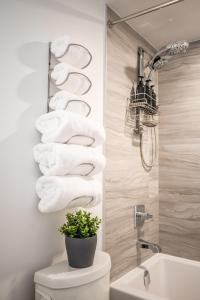 a bathroom with a toilet and a bunch of towels at Traveller home in centre Toronto in Toronto