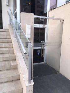an open glass door of a building with stairs at Apto climatizado -garagem in Florianópolis