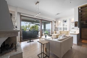 a living room with a couch and a fireplace at Afytos Wonder View by Luxlikehome in Afitos