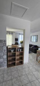 a kitchen with a counter and a living room at Un petit coin de Paradis dans la Brenne ! in Saint-Gaultier