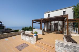 a patio of a house with a pavilion at Afytos Wonder View by Luxlikehome in Afitos