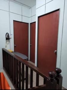a room with two sliding doors and a stair case at Andi Homestay in Sandakan +2 photos