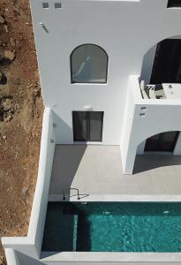 a house with a swimming pool in front of it at Shape-Infinity in Kalymnos