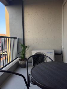 a black table and chairs on a balcony at Luxurious sandton apartment with Inverter in Sandton