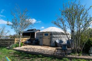 a yurt with a table and chairs in a yard at Lincoln Yurts in Lincoln