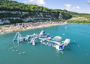 an aerial view of a water park with people on a pier at St Andrews Lakes 