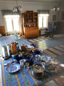 a table with a blue table cloth with dishes on it at Lillby Bed&Breakfast 