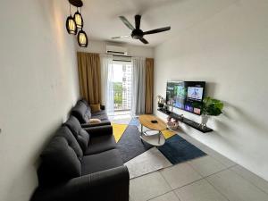 a living room with a couch and a flat screen tv at Holiday Inn Stay 3B2R Meritus Residensi Perai in Perai