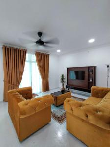 a living room with two couches and a flat screen tv at YY Homestay Pasir Mas in Pasir Mas