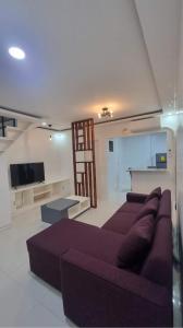 a living room with a couch and a tv at Brand New Camella 2 Bedroom House in Butuan