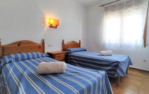 Postel nebo postele na pokoji v ubytování Apartaments Les Dunes