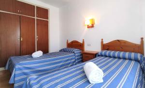 Postel nebo postele na pokoji v ubytování Apartaments Les Dunes