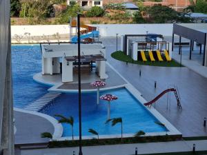 una piscina con un tobogán de agua y un parque infantil en Santa Cruz Hermoso Departamento Piscina Toboganes, en Santa Cruz de la Sierra