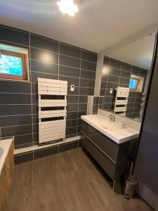 a bathroom with two sinks and a large mirror at Les Arcs - Chalet Arc Ô Mont in Arc 1600