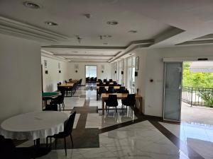 a banquet hall with tables and chairs in a room at Houston Resort in Radovljica
