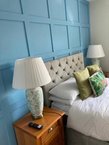 a bedroom with a bed and a table with a lamp at Overdale Motel in Lisburn