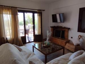 a living room with a couch and a table at κτήμα ΝΟΣΤΟΣ in Aigio