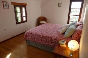 a bedroom with a bed and a table with a lamp at Summer Residence Illyria in Bribir