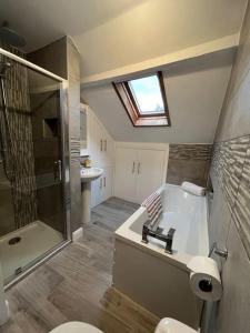 a bathroom with a toilet and a shower and a sink at Beautiful mid wales cottage in Garth +45 photos