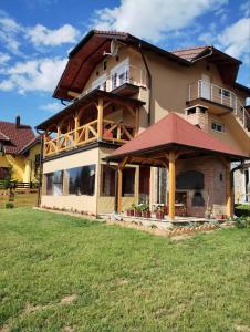 a large house with a wrap around porch at Apartmani Šarović Tara in Rača