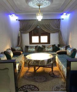 a living room with a couch and a table at Casa Del Flor in Larache