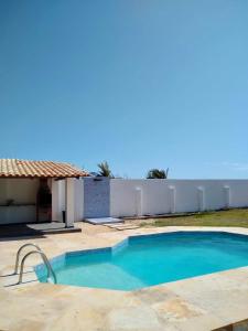 a swimming pool in front of a house at Casa de Praia no Morro Branco in Beberibe +19 photos