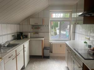 a small kitchen with a sink and a window at Fewo Itzehoe in Itzehoe