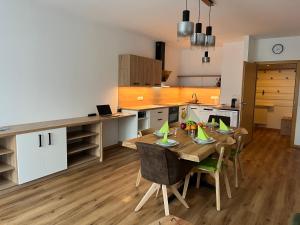 a kitchen and dining room with a table and chairs at Appartement NaMoll in Ausserfragant
