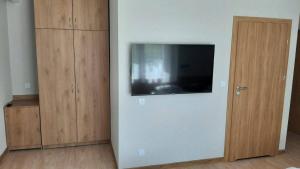 a room with a flat screen tv on a wall at Ośrodek Wypoczynkowy Graniczny in Zwardoń