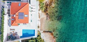 an overhead view of a house and the ocean at Epetium Beach Villa in Split