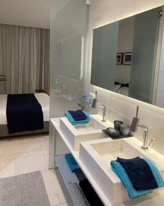 a bathroom with two sinks and a bed and a mirror at Casa Las Olas in Palm-mar