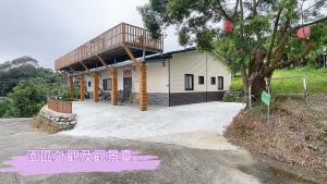 a house with a deck on top of it at 沐星園villa in Tung-k'eng-ts'un