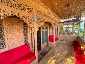 a train car with red seats in a room at Nazneen Group Of Houseboats in Srinagar