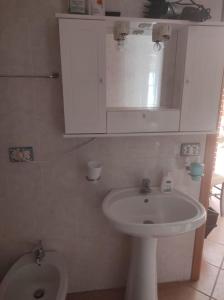 La salle de bains est pourvue d'un lavabo blanc et de toilettes. dans l'établissement Casa Vacanze Le Vigne, à Rionero Sannitico