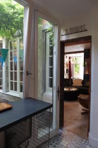 a glass door leading into a living room at Atelier des Glycines, Troyes Bouchon de Champagne, Sublime site patrimonial in Troyes +49 photos
