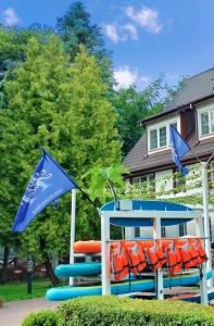 a playground with orange and blue chairs and a flag at Great Polonia Beach & Molo in Puck