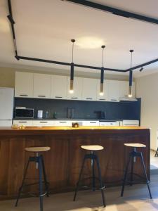 a kitchen with a wooden counter and stools at G apartment in Plovdiv