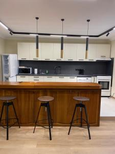 a kitchen with two bar stools and a counter at G apartment in Plovdiv