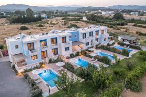 an aerial view of a villa with two swimming pools at RITA MARE seafront villas heated Pools in Gennadi