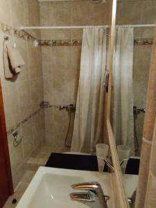 a bathroom with a sink and a shower at κτήμα ΝΟΣΤΟΣ in Aigio +28 photos