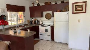 a kitchen with a white refrigerator and a stove at Palma Real 3xBedroom Villa Z45 in Roma