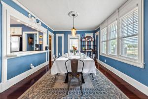 a dining room with blue walls and a table with chairs at The Kenwood Gables in St Petersburg