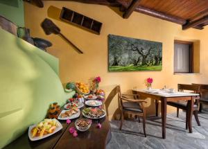 a table with plates of food on top of it at Alkifron Hotel in Kala Nera
