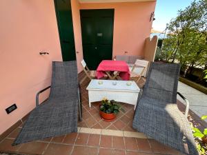a patio with two chairs and a table on a house at B&B Garda 4U in Desenzano del Garda
