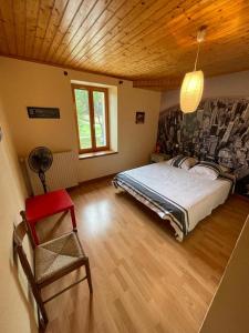 um quarto com uma cama grande e um tecto de madeira em le Pigeonnier gersois em Condom