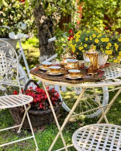 a table with plates of food and flowers on it at Casa Rosca in Sighişoara