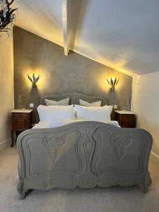 a bedroom with a large gray bed with white pillows at Château 9 Neuf in Newark-on-Trent