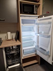 a refrigerator with its door open and a microwave at Tavio mobile house Kolpa, BIG BERRY, Metlika in Metlika +42 photos