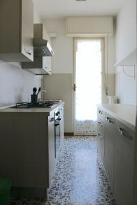 a kitchen with a sink and a stove top oven at Frattini Comfy family Home - 4 People in Milan